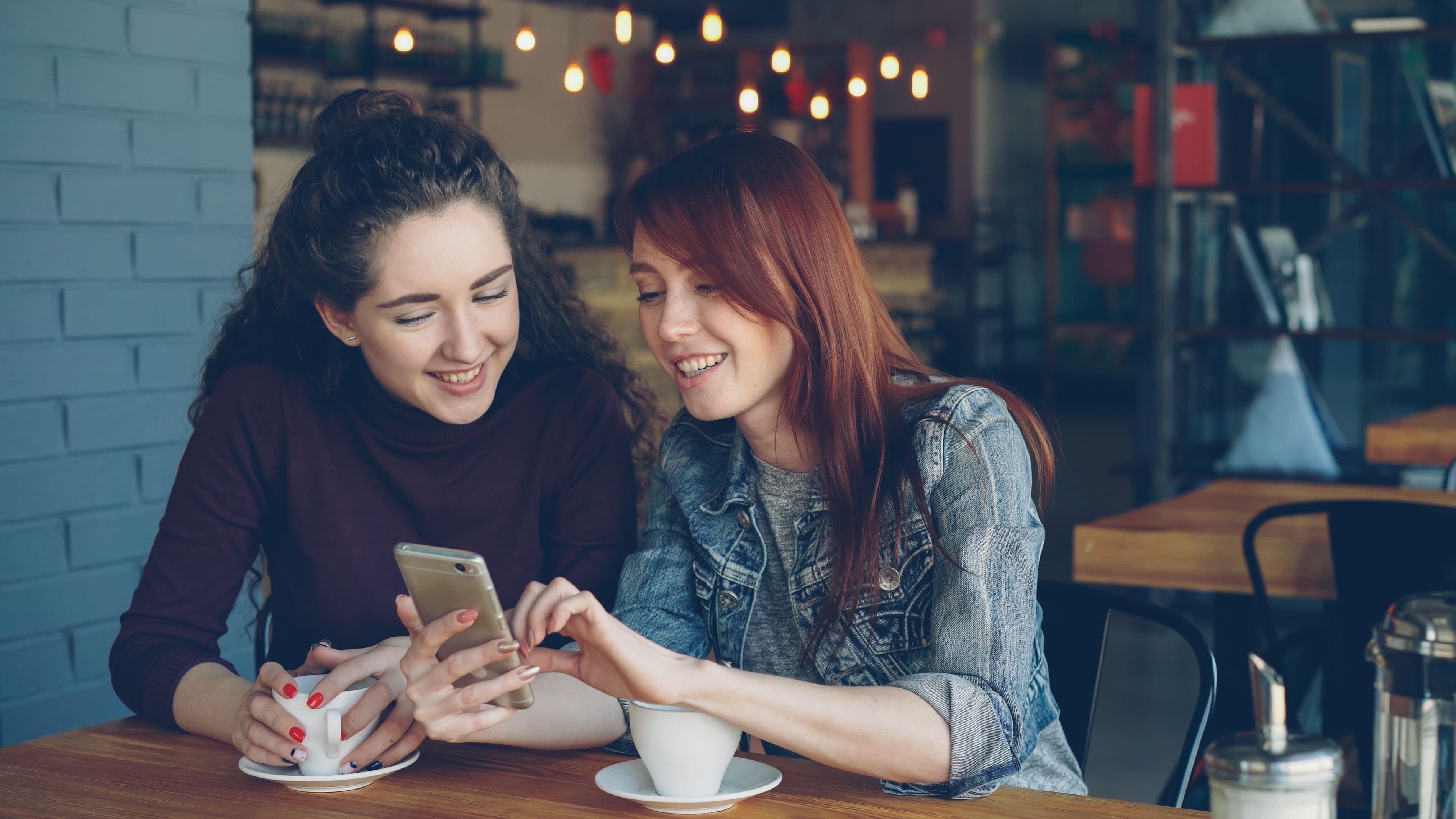 Friends at a restaurant looking at a menu on their phone